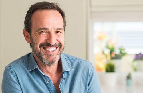 a man smiling with natural-looking dentures