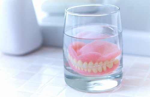 dentures in a glass of water