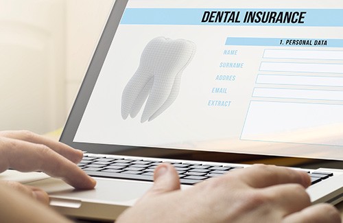 a patient filling out a dental insurance form