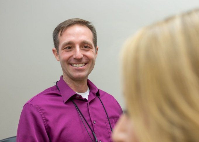 Man grinning while sitting in dental chair