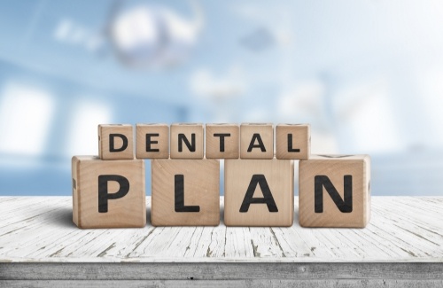 Wooden block letters spelling out the words dental plan