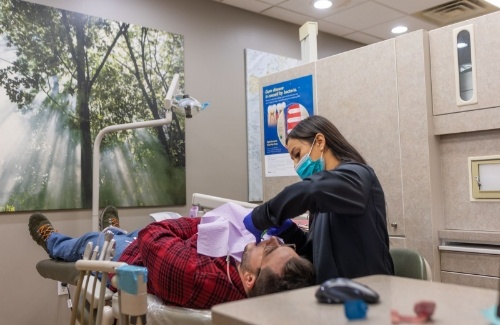 Dental team member showing paperwork to patient