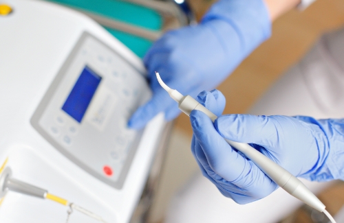 Dental team member holding laser device