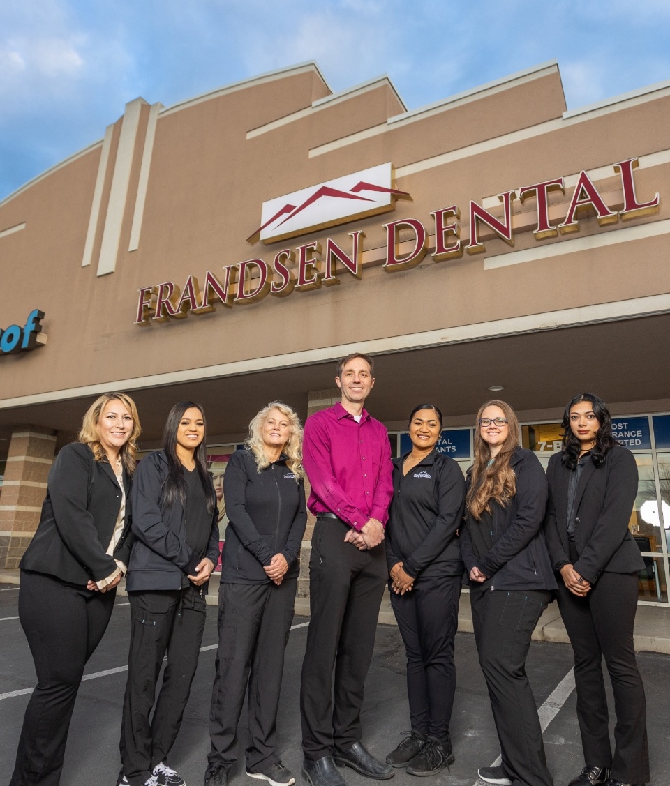 Smiling dentists and tea standing outside of Frandsen Dental of West Jordan