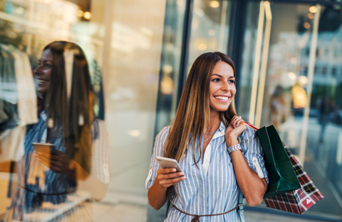 Woman smiling while shopping at outdoor mall