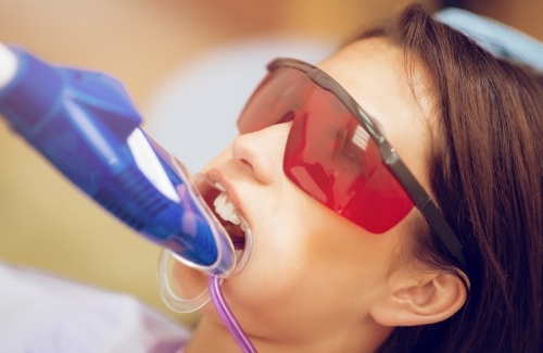 Girl in dental chair with fluoride on her teeth